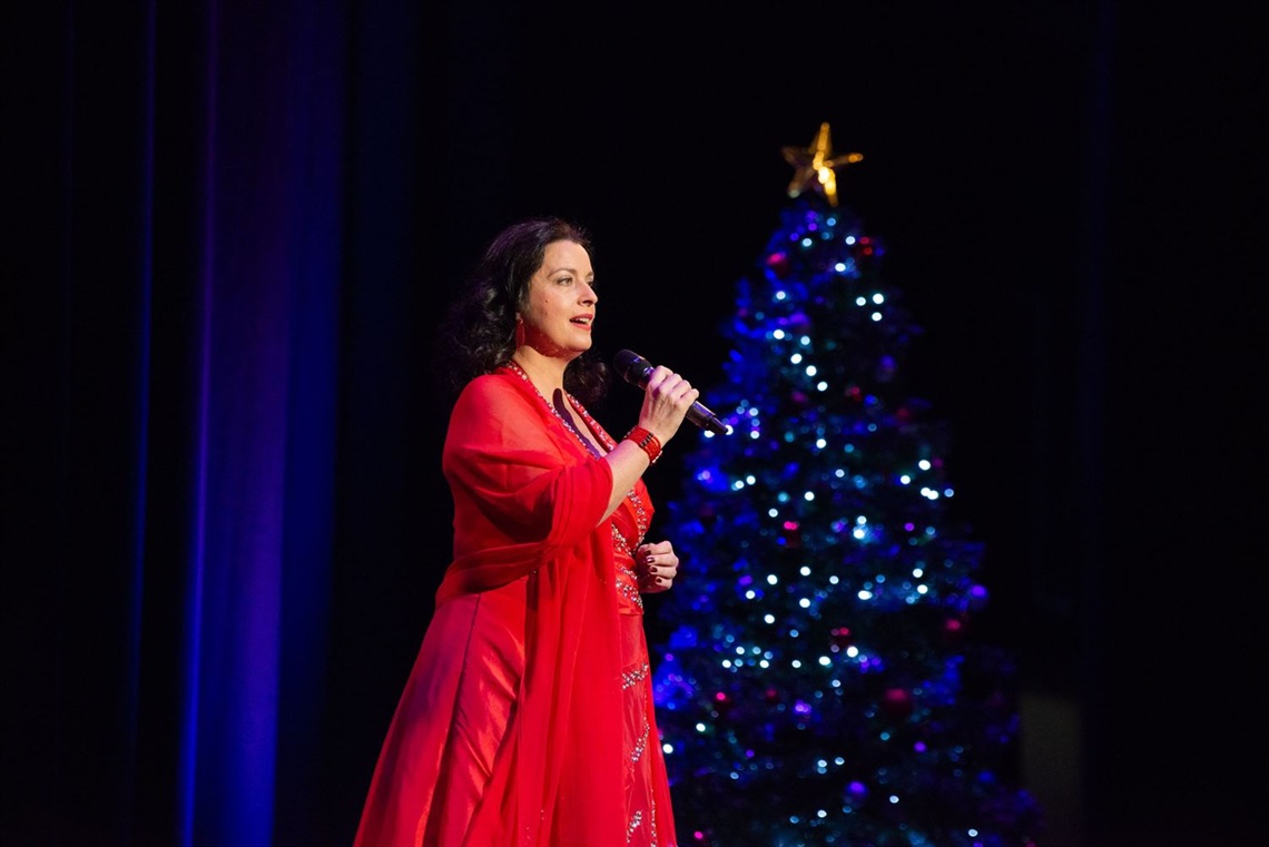 Michelle Christmas with Tree.jpeg